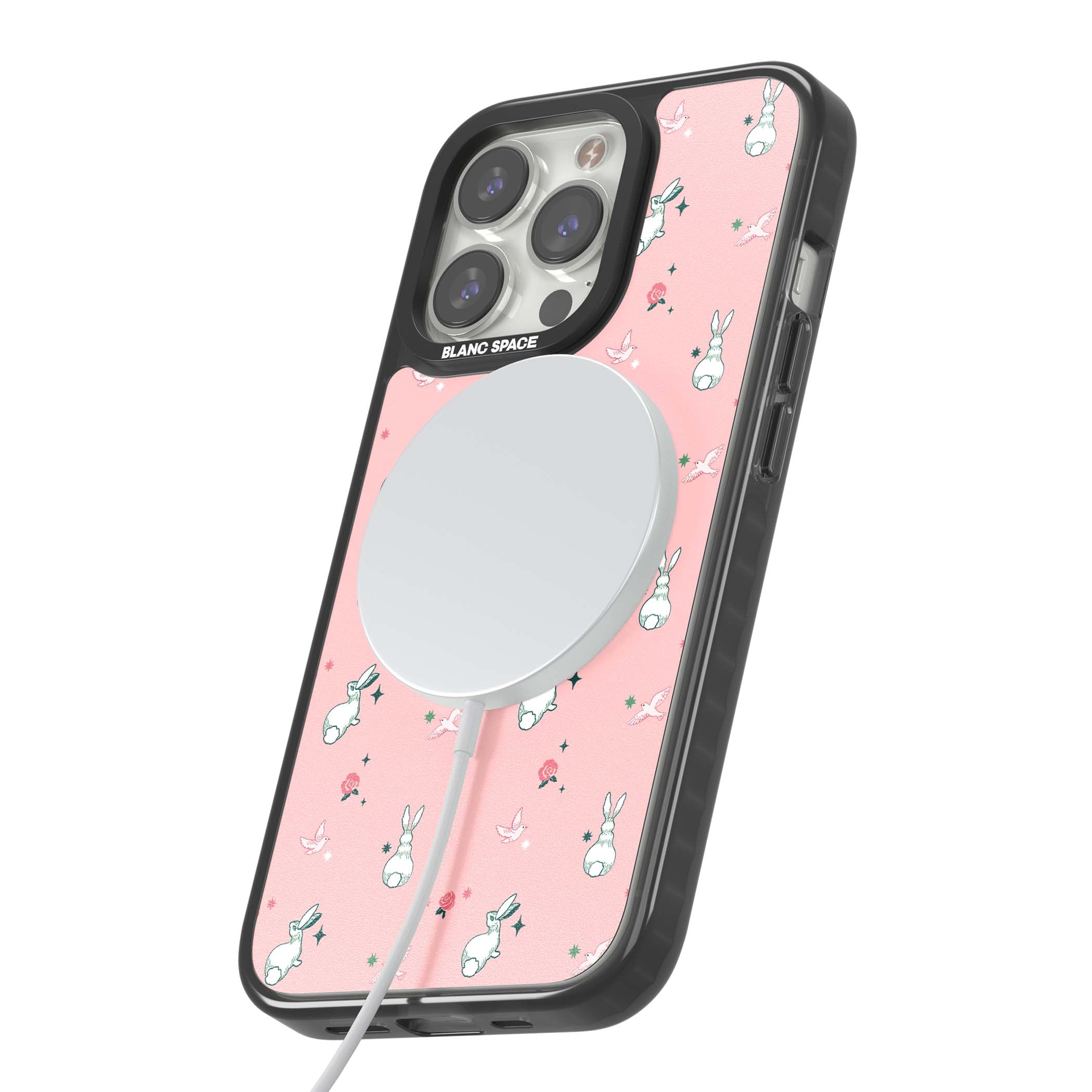 Bunny Garden kawaii iPhone case featuring white rabbits, pink roses, doves and stars on pink background | Black Impact Magsafe case for iPhone 13 Pro, iPhone 14 Pro, iPhone 15 Pro